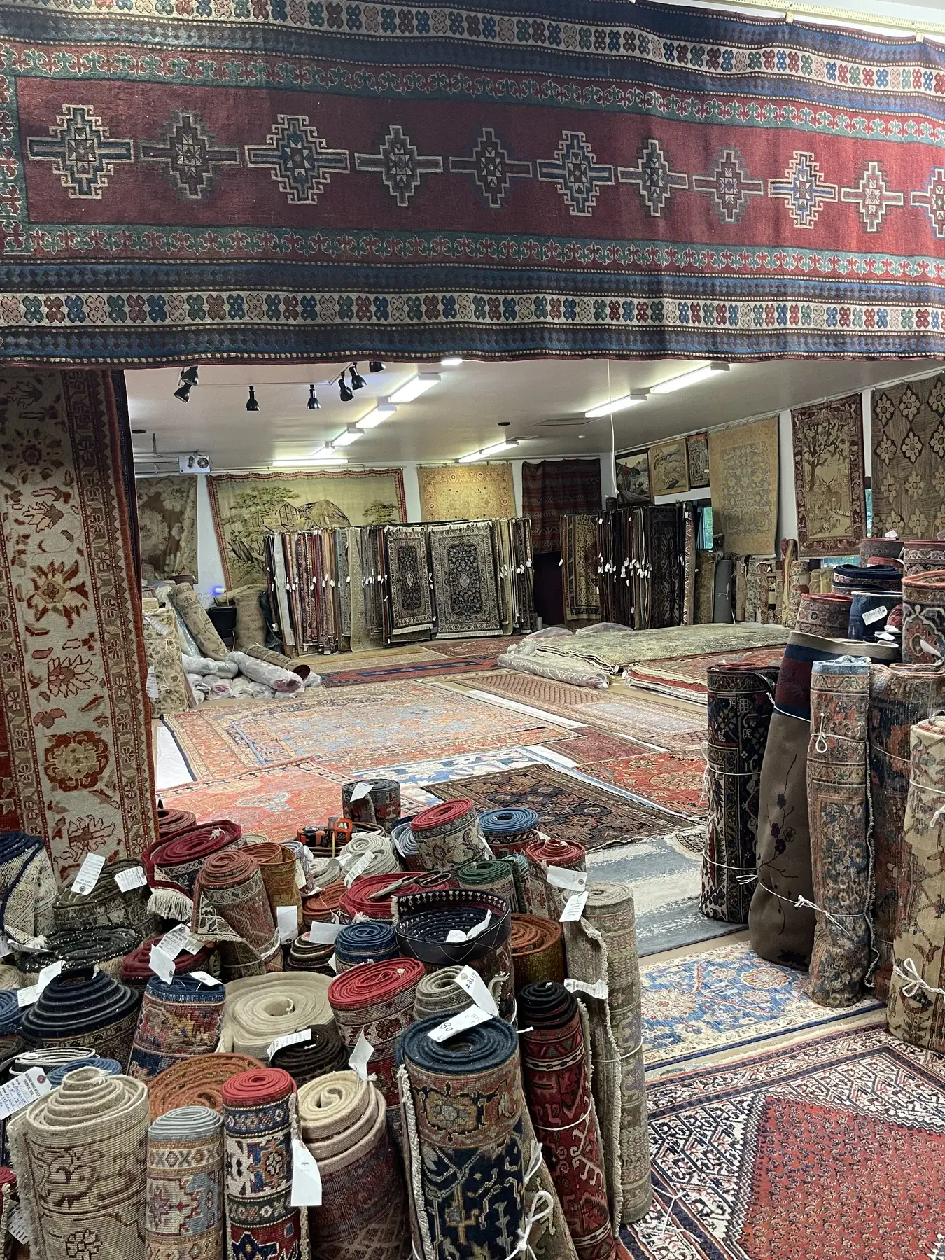 Colorful rugs displayed throughout the Woodbury gallery